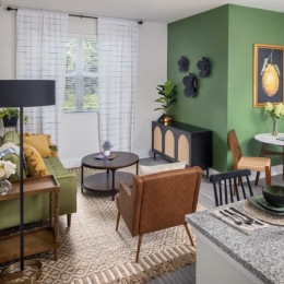 a living room with a couch, tables and chairs