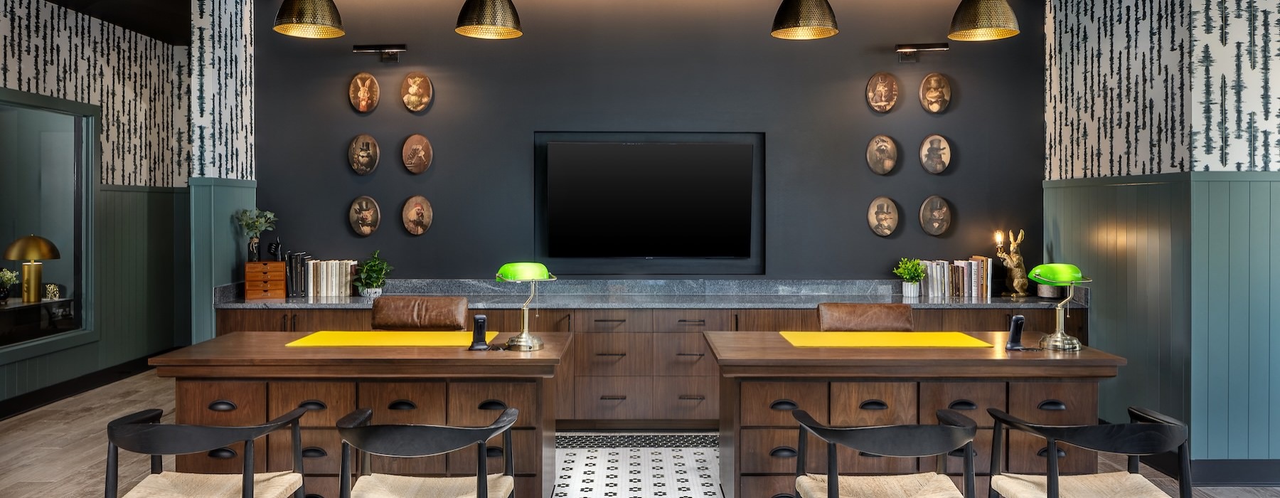 a leasing office with a tv, desks and chairs