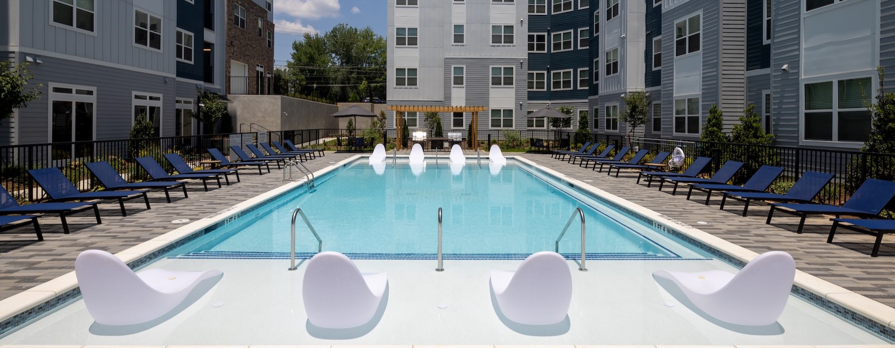 a swimming pool with lounge chairs